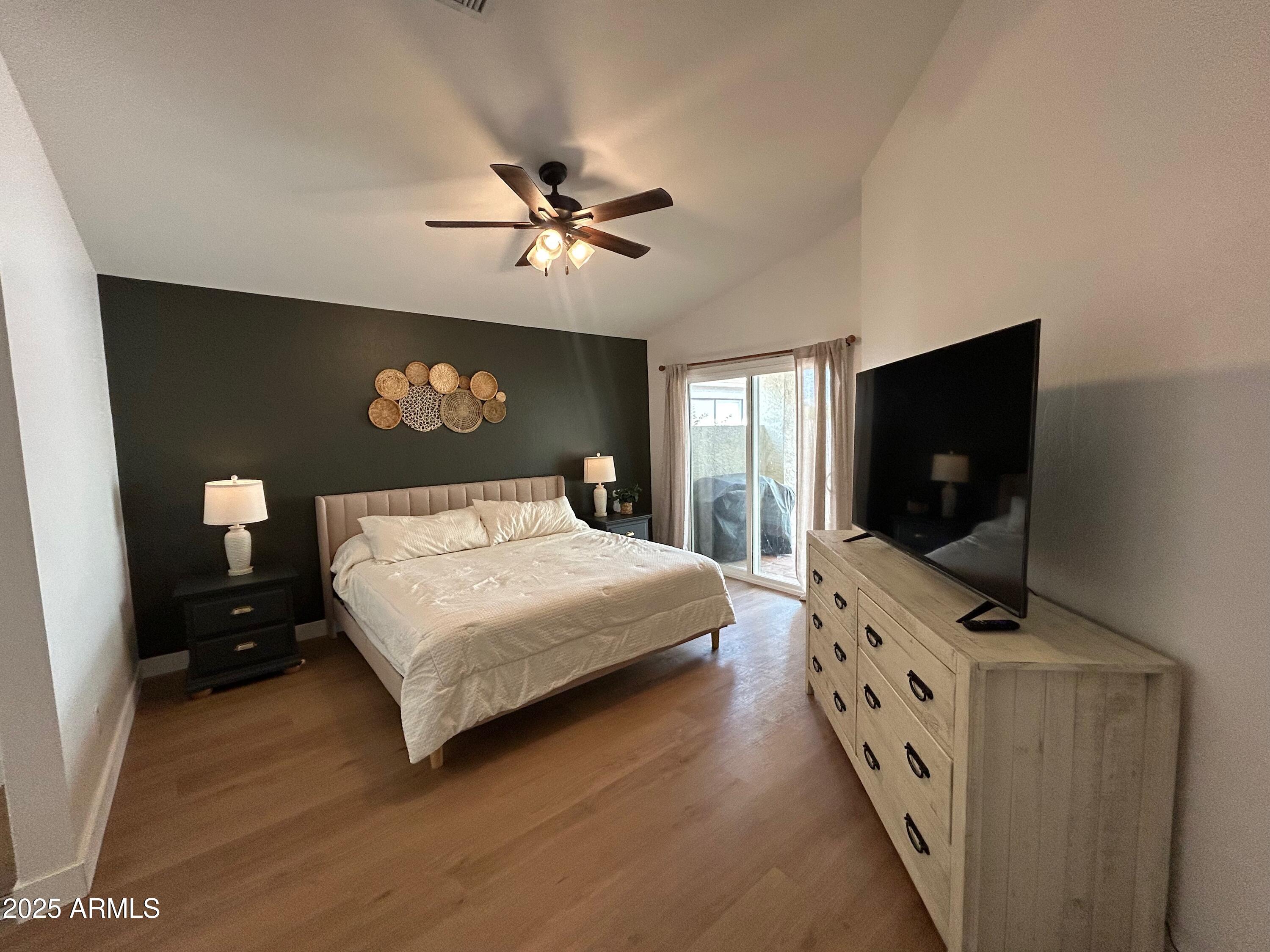 4725 East Brown Road, Unit 57 Mesa, AZ 85205 - Photo 5 of 14 a bedroom with a bed and a flat screen tv