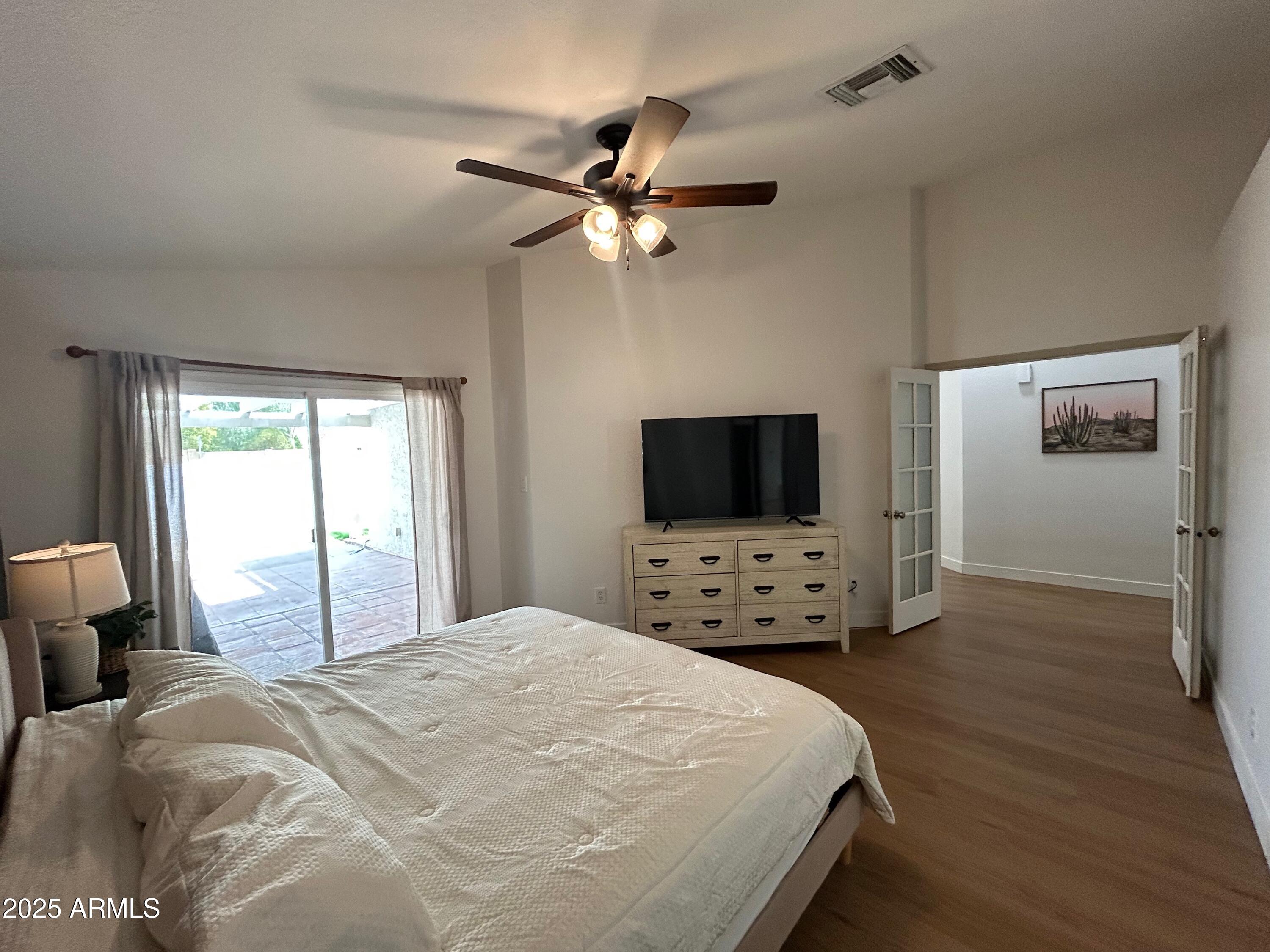 4725 East Brown Road, Unit 57 Mesa, AZ 85205 - Photo 6 of 14 a bedroom with a bed and a flat screen tv