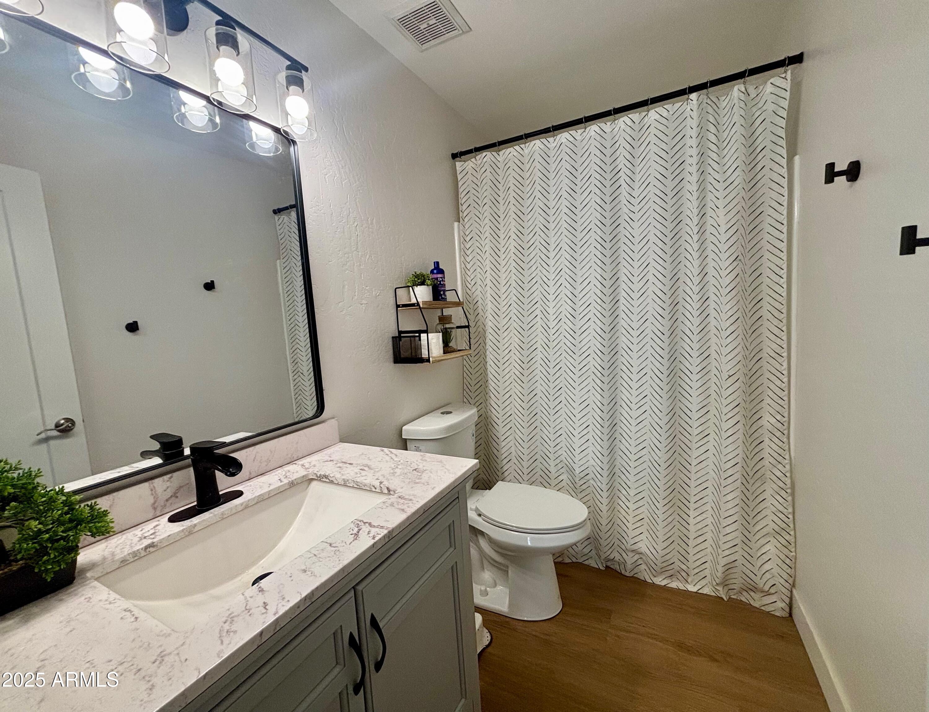 4725 East Brown Road, Unit 57 Mesa, AZ 85205 - Photo 10 of 14 a bathroom with a granite countertop sink and a mirror