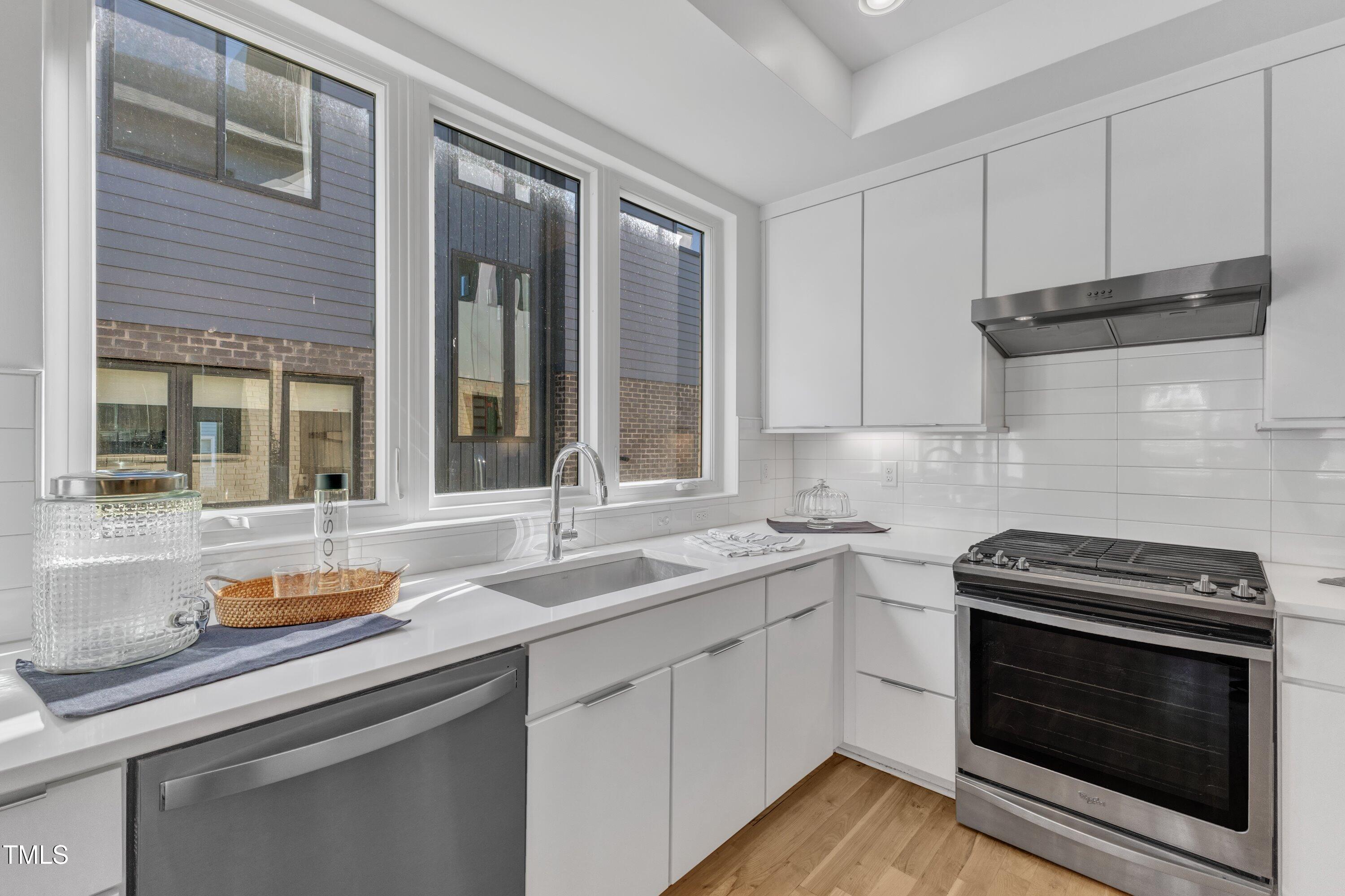 524 East Edenton Street Raleigh, NC 27601 - Photo 15 of 70 a kitchen with cabinets appliances a sink and a counter top