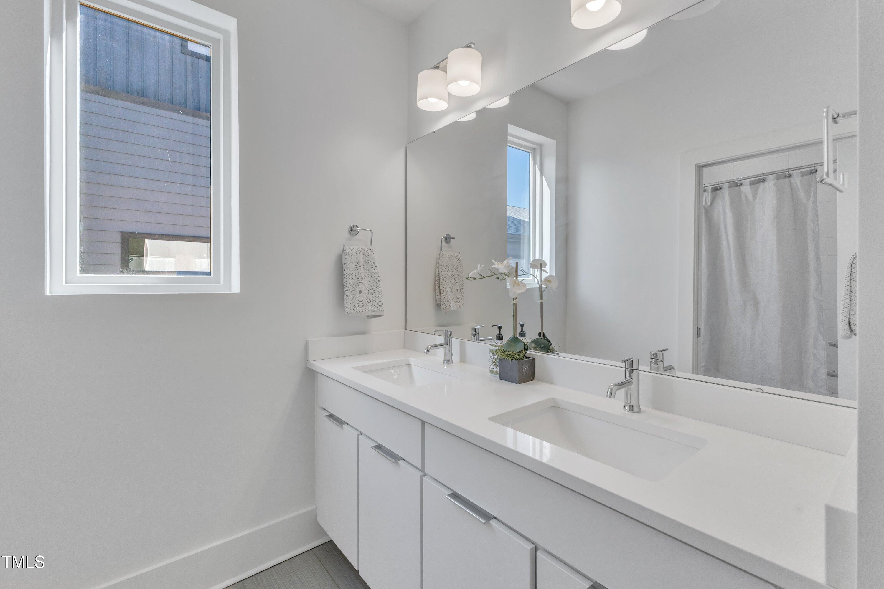 524 East Edenton Street Raleigh, NC 27601 - Photo 38 of 70 a bathroom with a sink and a mirror