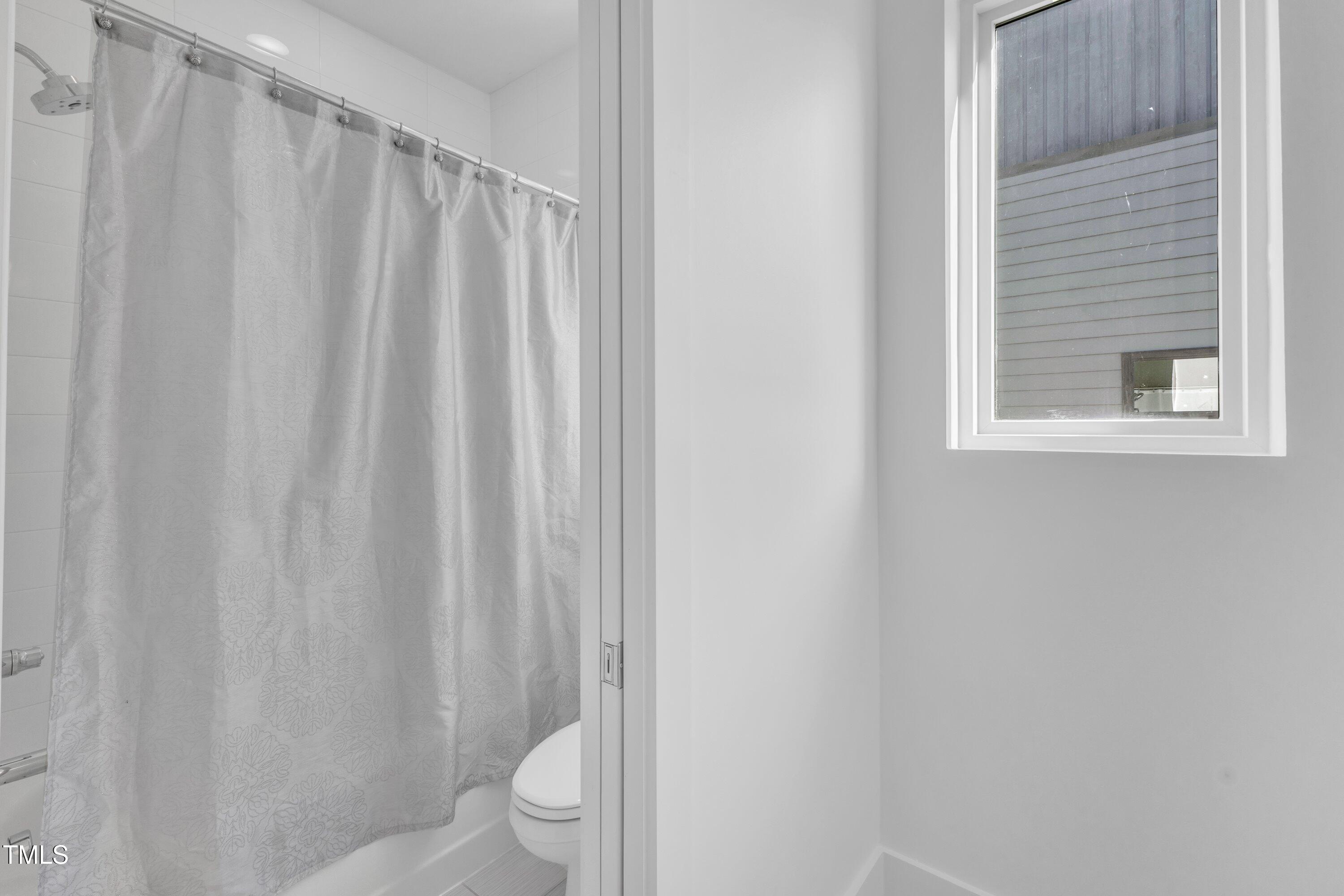 524 East Edenton Street Raleigh, NC 27601 - Photo 39 of 70 a bathroom with a shower curtain and a toilet