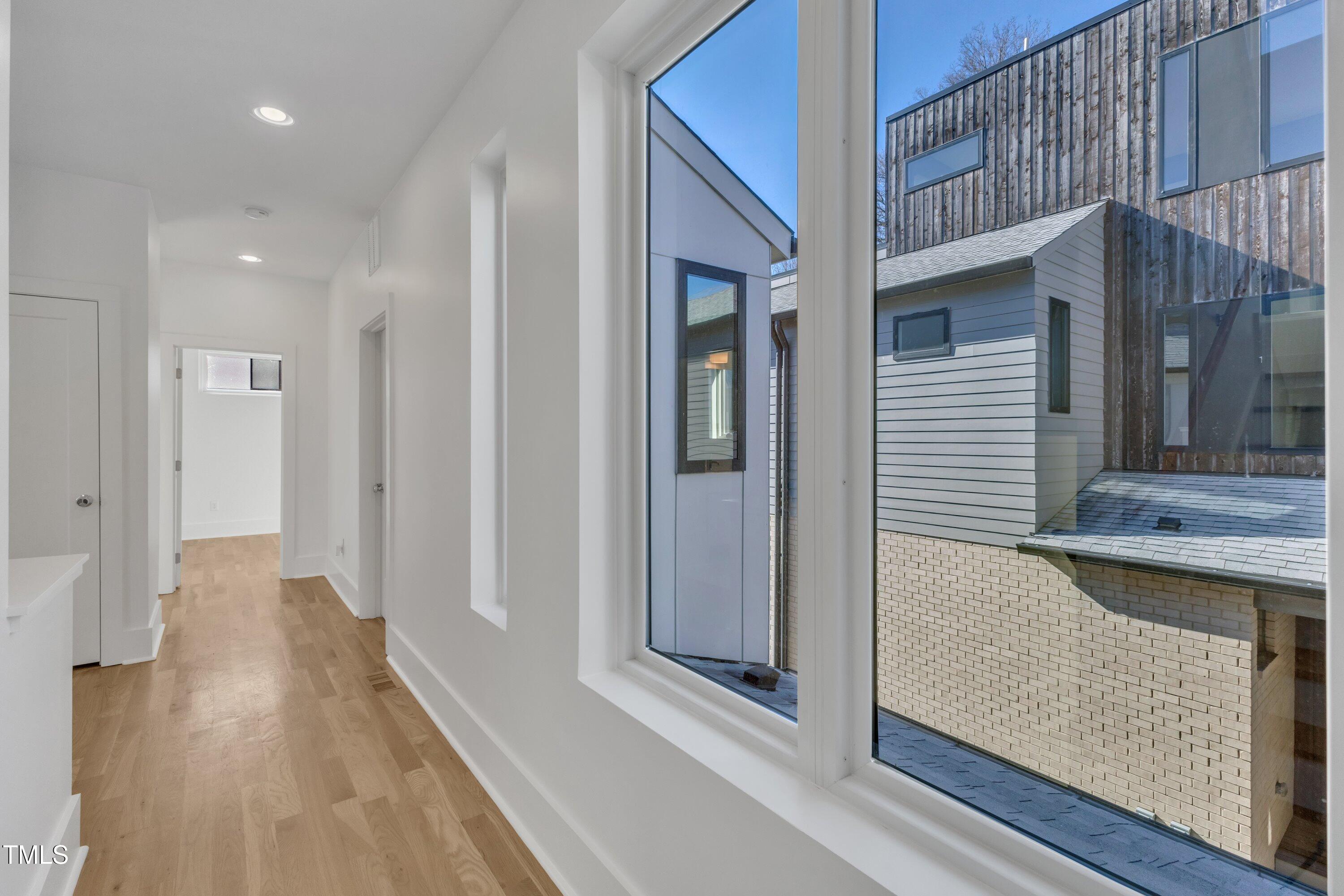 524 East Edenton Street Raleigh, NC 27601 - Photo 40 of 70 a view of a hallway with wooden floor and staircase