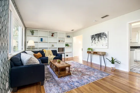 a bath room with a mirror and a bath tub