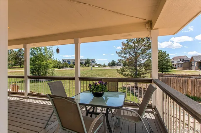 a view of a chairs and table on the wooden deck