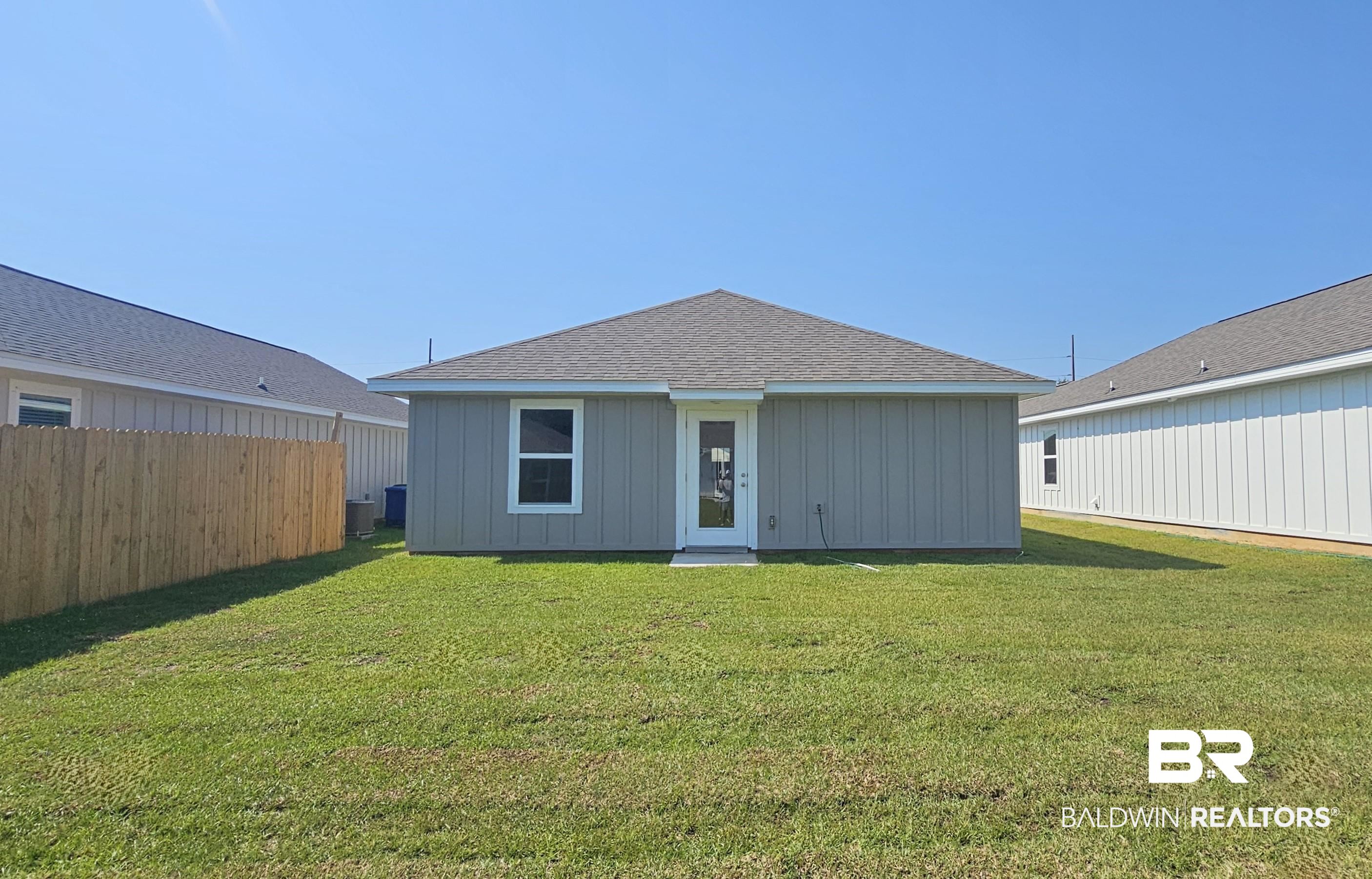 1152 Sweet Laurel Street Foley, AL 36535 - Photo 2 of 4 Rear view of house with a lawn