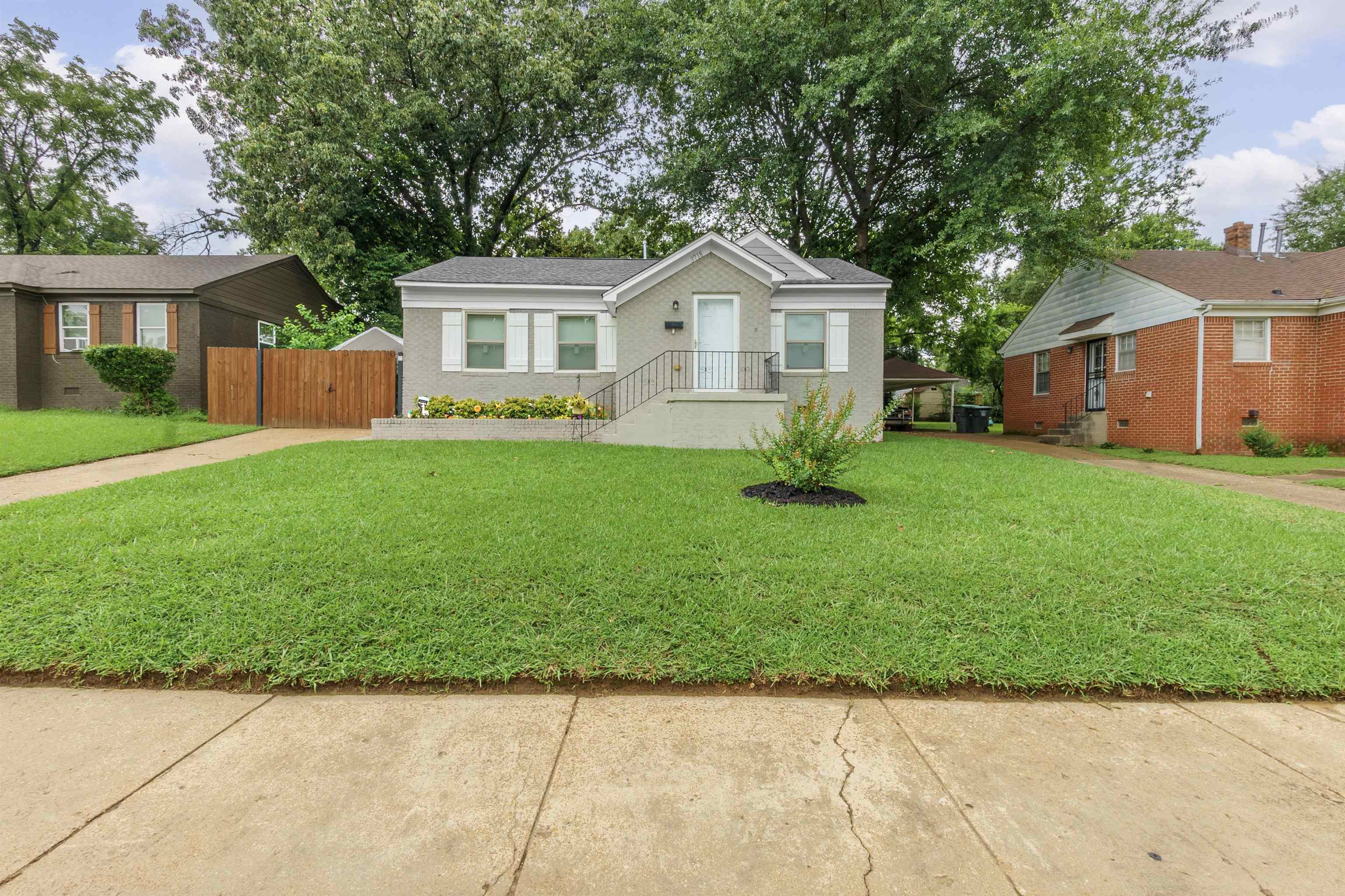 a front view of a house with a garden
