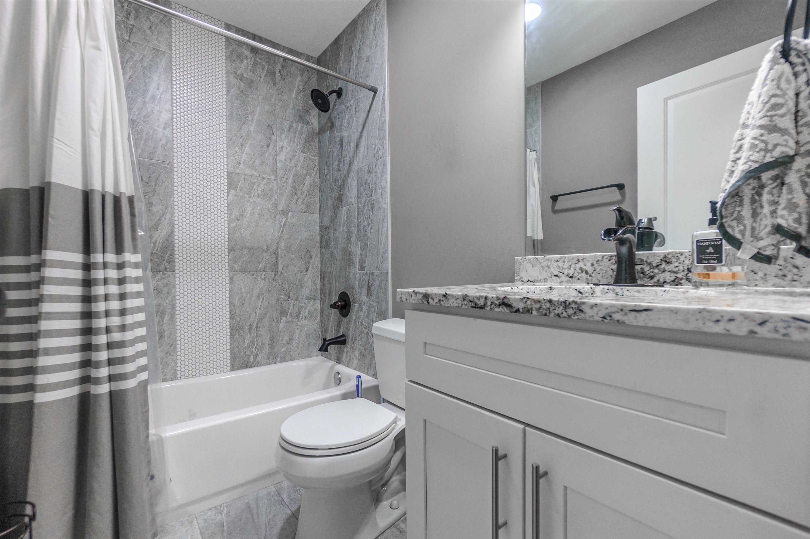 3718 Vanuys Road Memphis, TN 38111 - Photo 11 of 20 a bathroom with a granite countertop sink toilet and shower