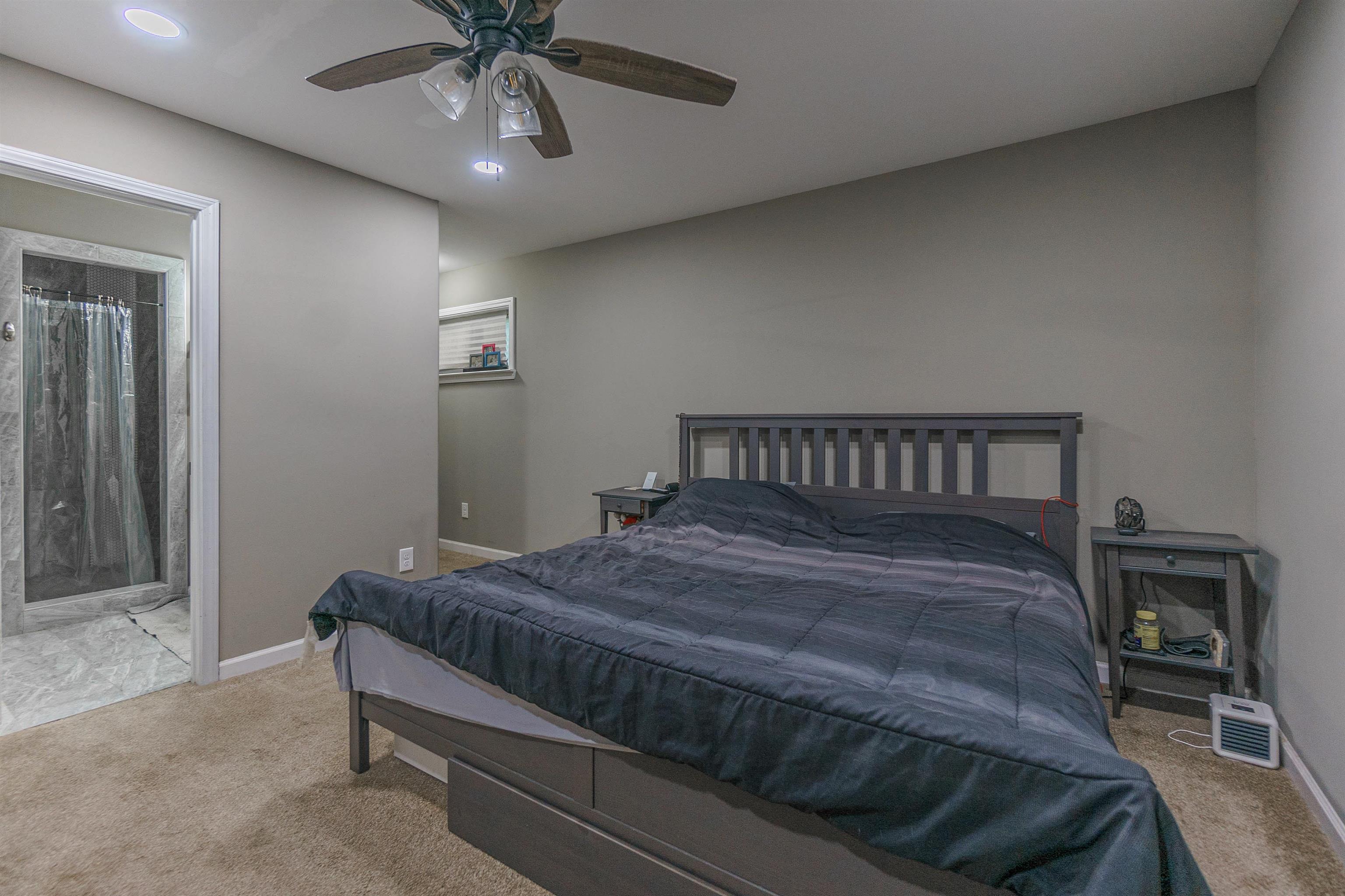 3718 Vanuys Road Memphis, TN 38111 - Photo 16 of 20 a bedroom with a bed and a chandelier