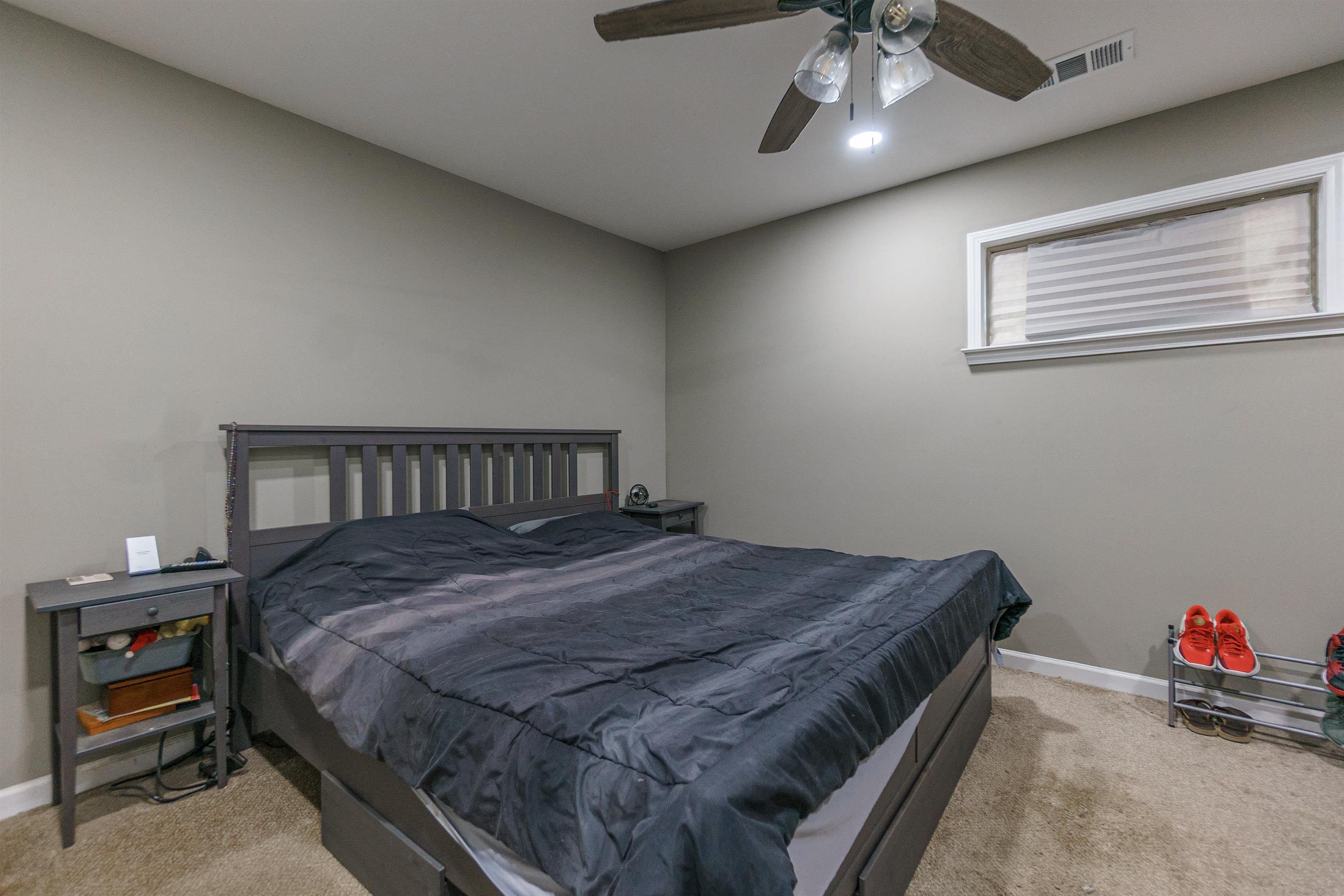 3718 Vanuys Road Memphis, TN 38111 - Photo 17 of 20 a bedroom with a bed and a chandelier