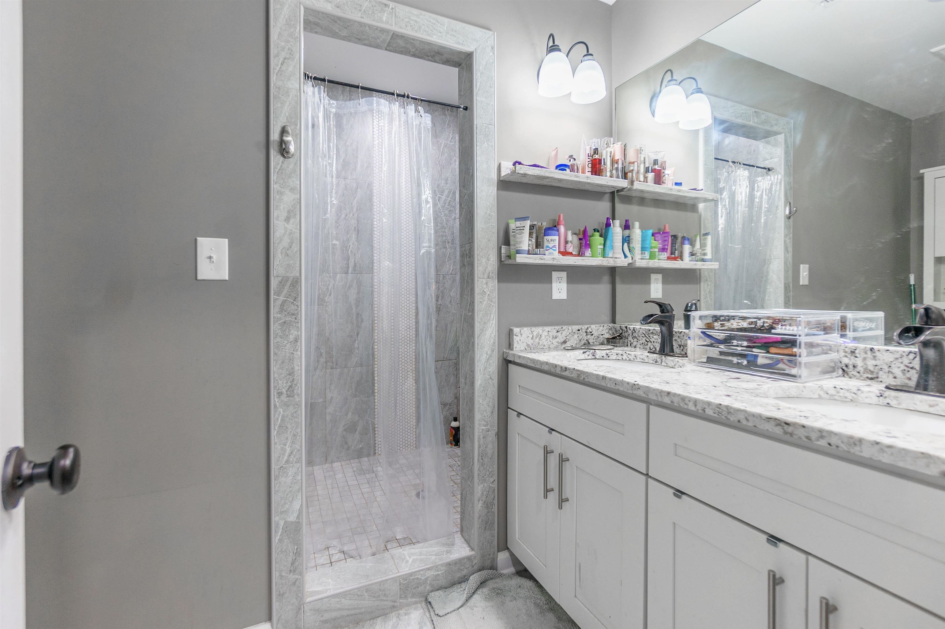 3718 Vanuys Road Memphis, TN 38111 - Photo 18 of 20 a bathroom with a granite countertop sink and a mirror