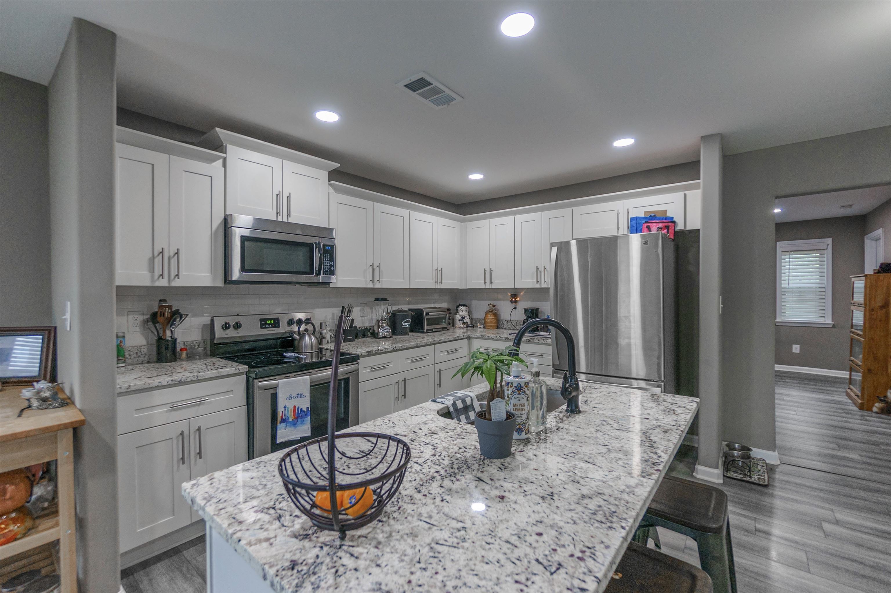3718 Vanuys Road Memphis, TN 38111 - Photo 7 of 20 a kitchen with stainless steel appliances granite countertop a stove refrigerator sink and cabinets