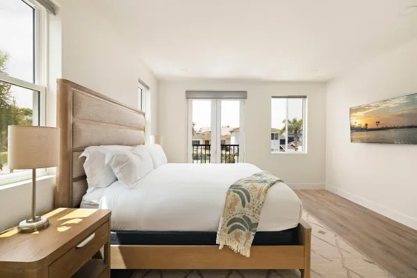 a bedroom with a bed and a window