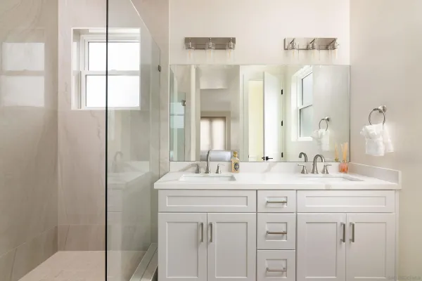 a bathroom with a sink a mirror and a shower