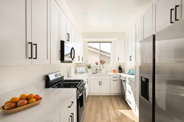 a kitchen with a sink stove and refrigerator