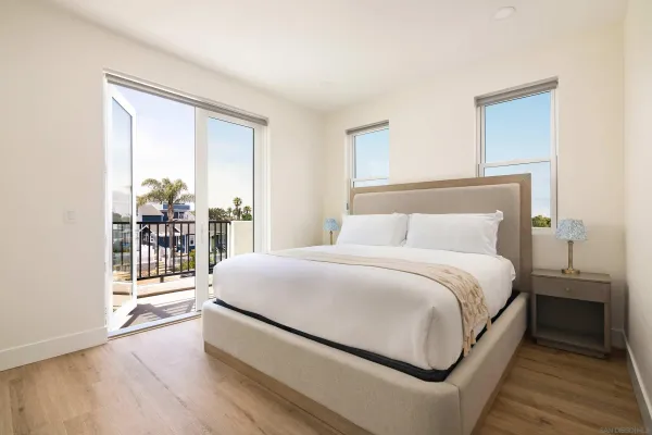 a bedroom with a bed and a large window