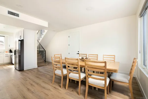 a kitchen with stainless steel appliances white cabinets granite counter tops and a wooden floor
