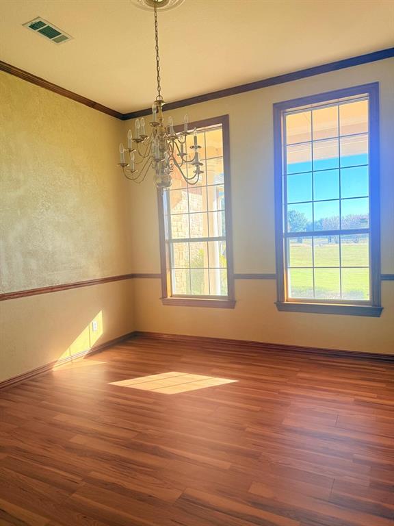 10200 Zipper Road Pilot Point, TX 76258 - Photo 16 of 18 a view of an empty room with wooden floor and a window