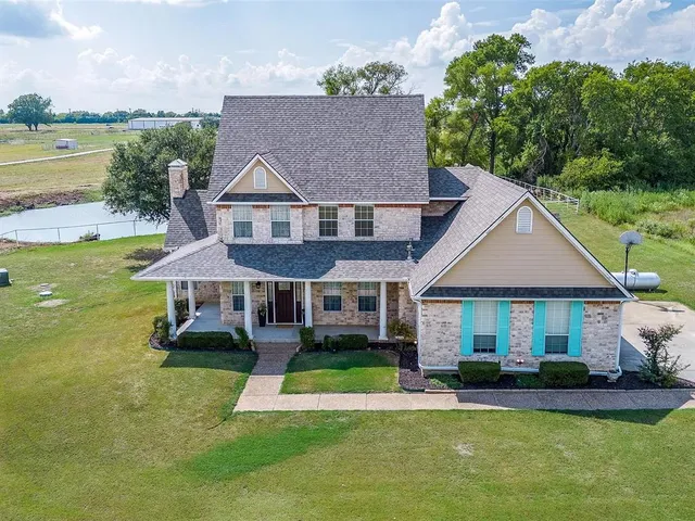 an aerial view of a house with swimming pool yard and outdoor seating