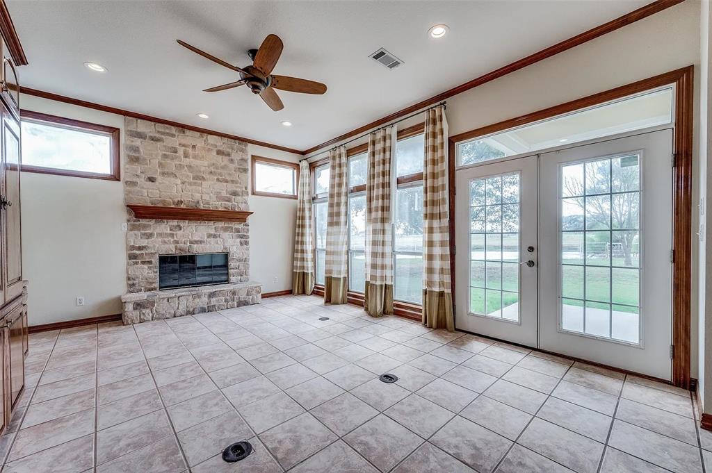 10200 Zipper Road Pilot Point, TX 76258 - Photo 6 of 18 a view of an empty room with windows and fireplace
