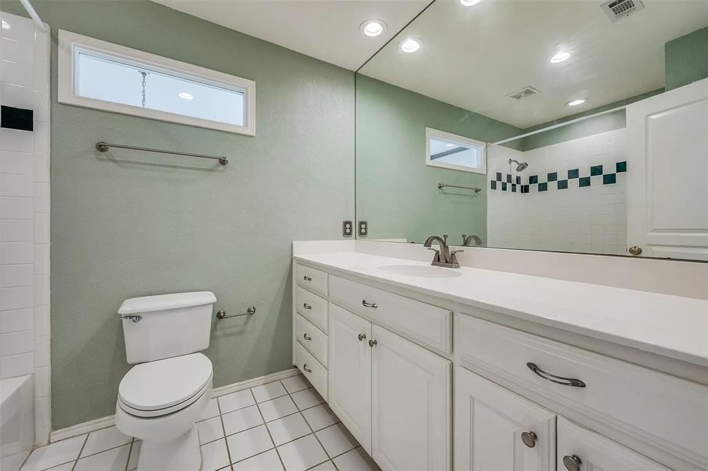 10200 Zipper Road Pilot Point, TX 76258 - Photo 7 of 18 a bathroom with a toilet sink and mirror