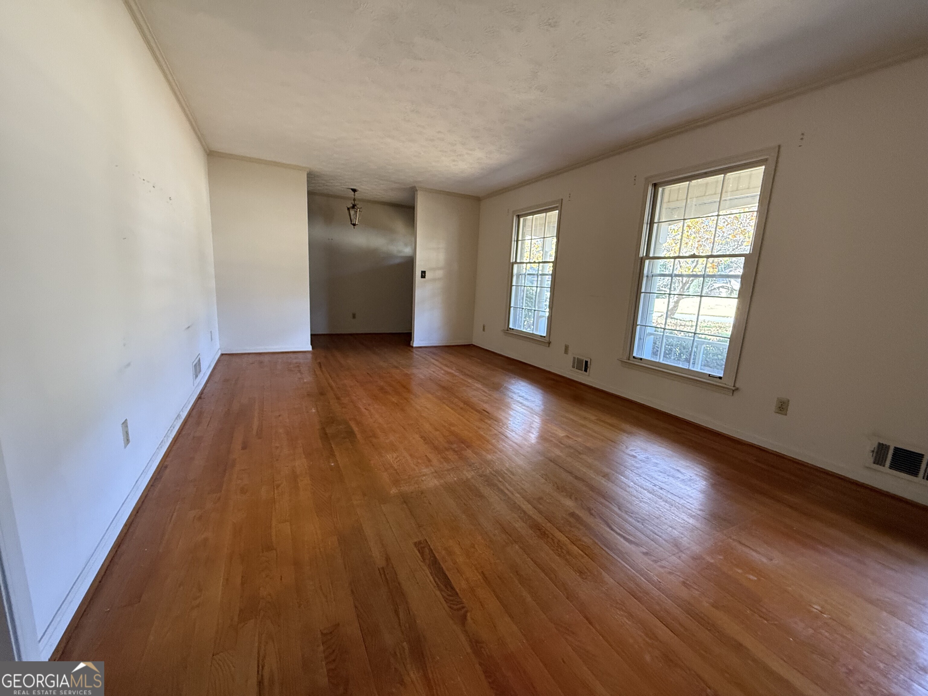 5904 Foxfield Trail Rex, GA 30273 - Photo 4 of 13 an empty room with wooden floor and windows