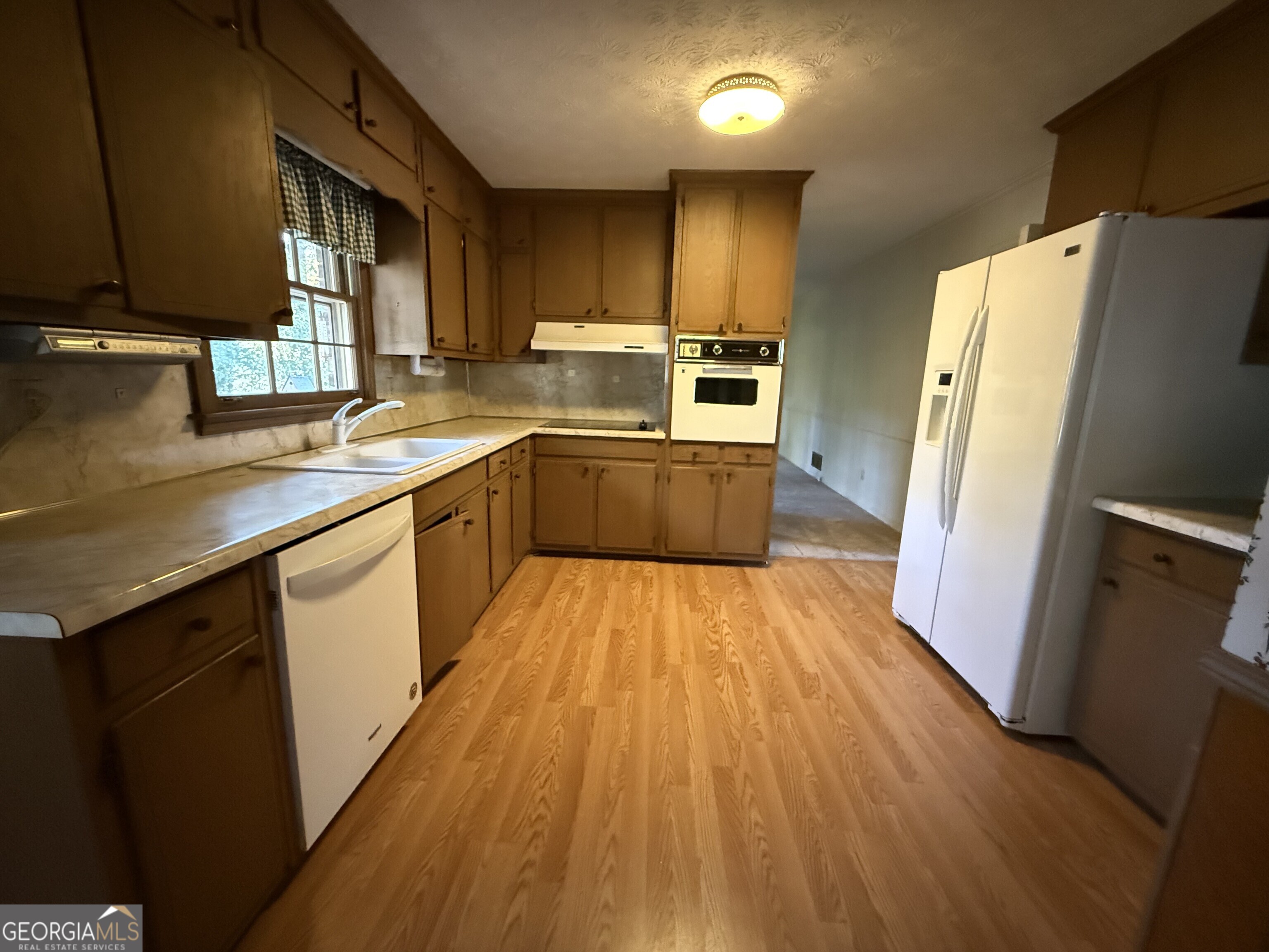 5904 Foxfield Trail Rex, GA 30273 - Photo 5 of 13 a kitchen with wooden floors appliances
