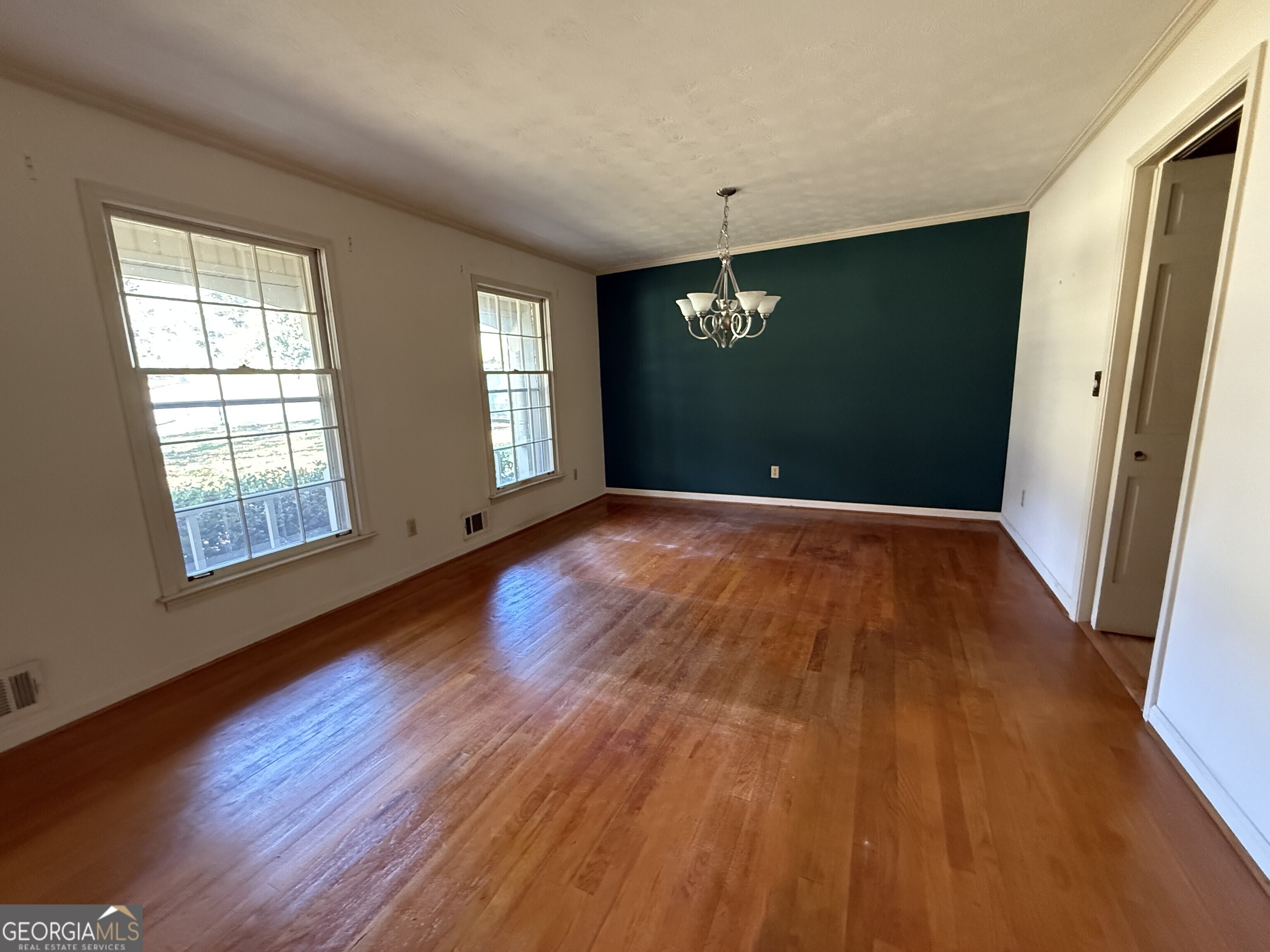 5904 Foxfield Trail Rex, GA 30273 - Photo 6 of 13 an empty room with wooden floor and windows