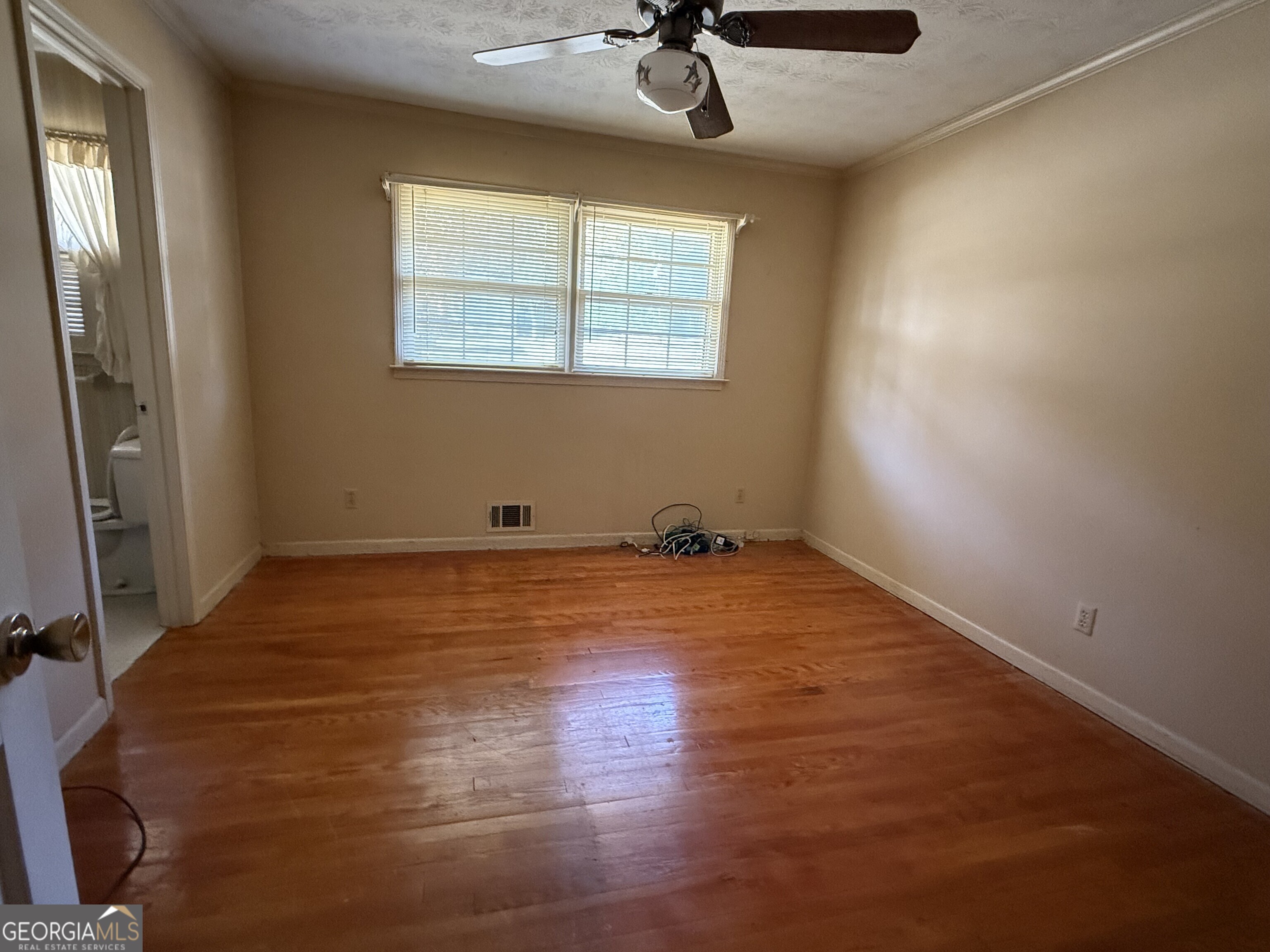 5904 Foxfield Trail Rex, GA 30273 - Photo 8 of 13 a view of empty room with wooden floor and fan