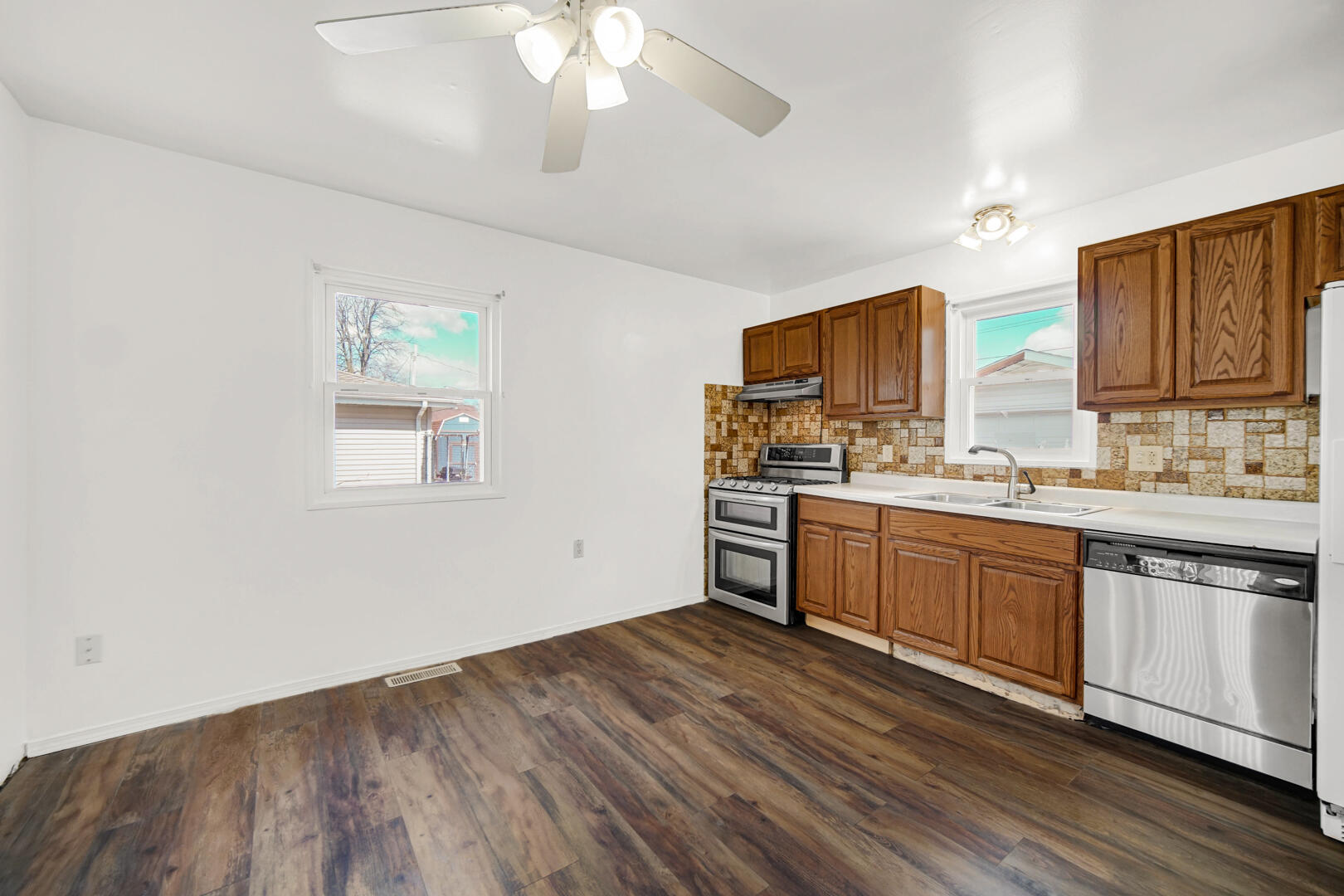 769-1 Juniper Road Valparaiso, IN 46385 - Photo 8 of 20 a kitchen with stainless steel appliances granite countertop a stove cabinets and wooden floor