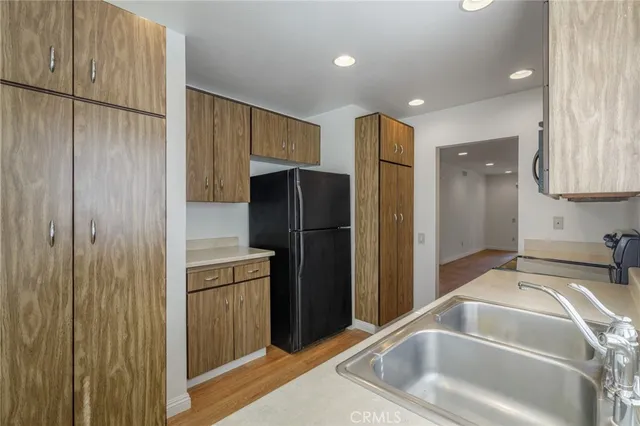 a kitchen with a refrigerator and a sink
