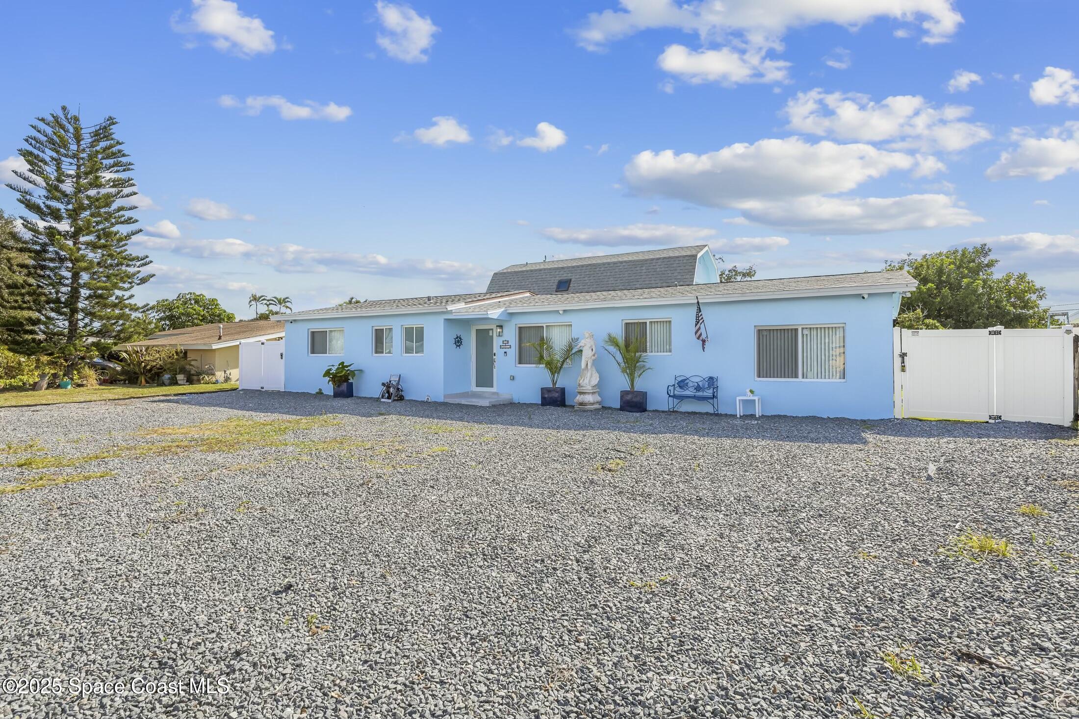 a view of a house with backyard and sitting area