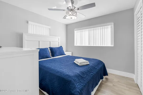 a bed sitting in a bedroom next to a window