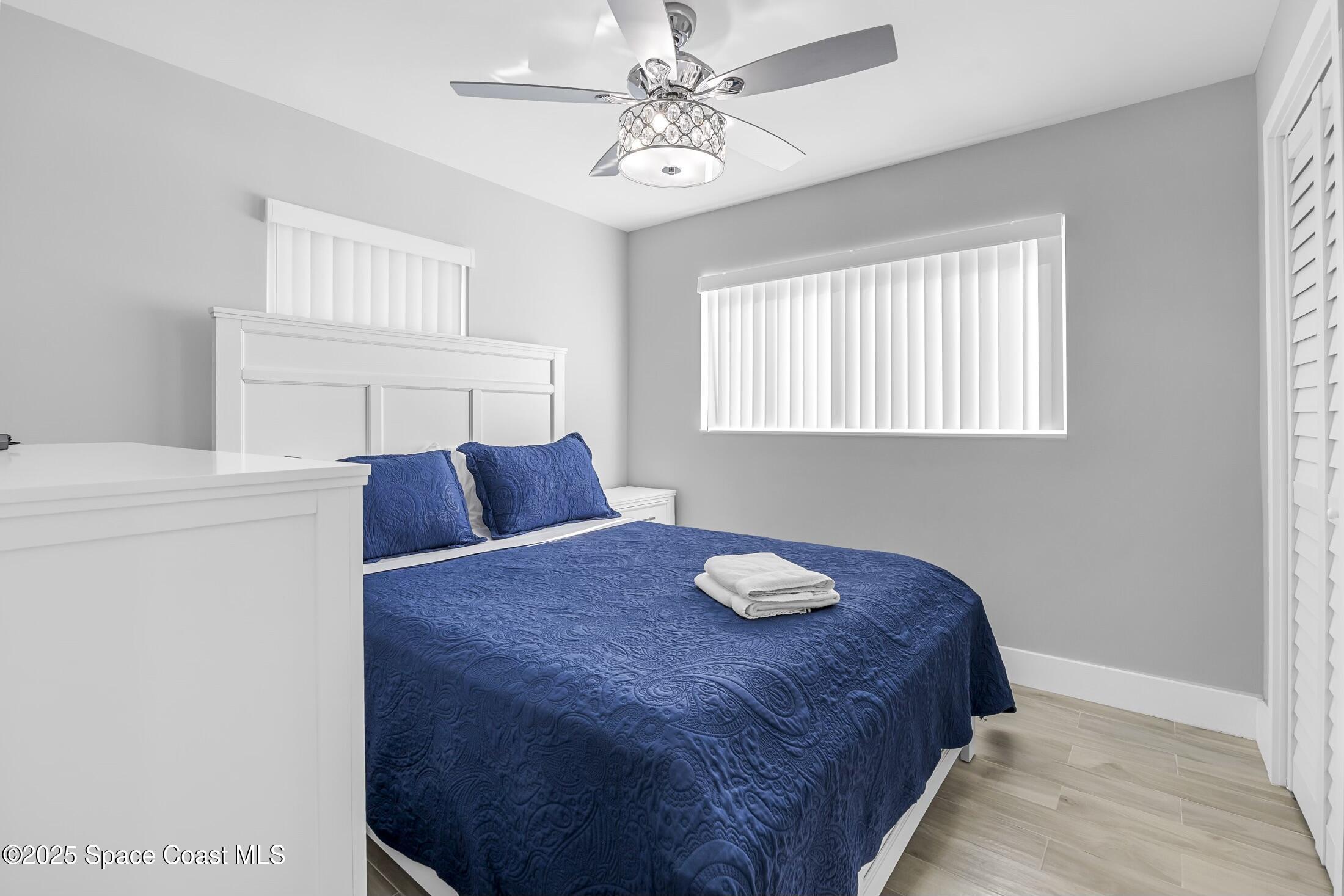 236 Northeast 3rd Street Satellite Beach, FL 32937 - Photo 14 of 22 a bed sitting in a bedroom next to a window