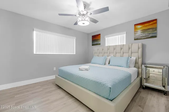 a bedroom with a large bed and a chandelier