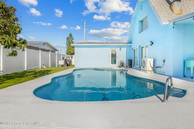 a view of a living room with kitchen