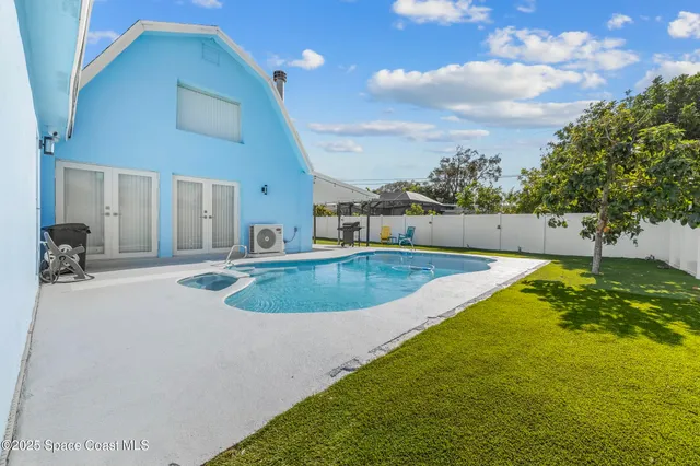 a view of a swimming pool with a yard