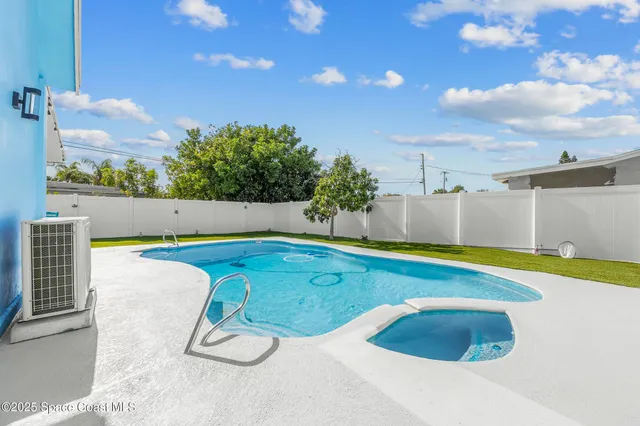 a view of swimming pool with seating space