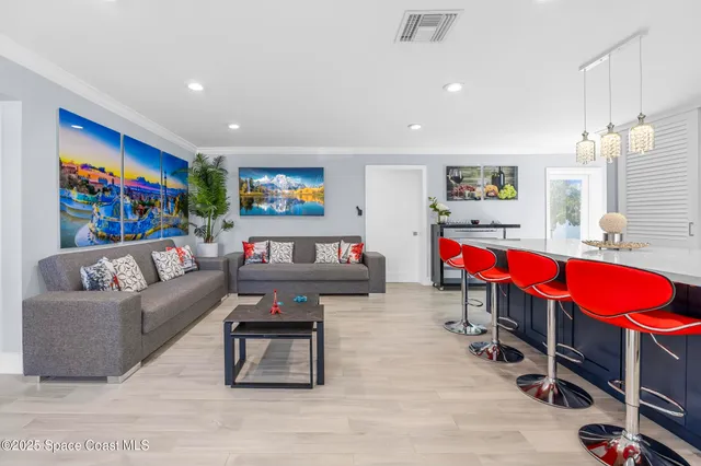 a living room with furniture a rug and a flat screen tv
