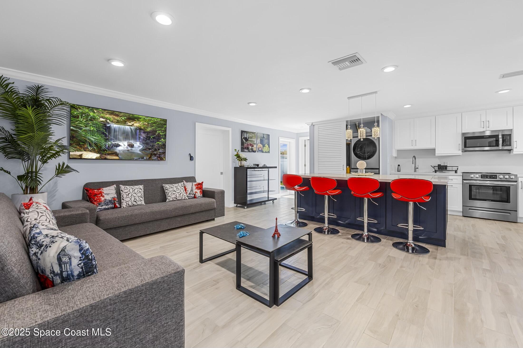 236 Northeast 3rd Street Satellite Beach, FL 32937 - Photo 5 of 22 a living room with furniture and kitchen view