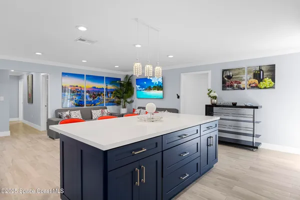 a view of kitchen with stainless steel appliances kitchen island a large island in the center