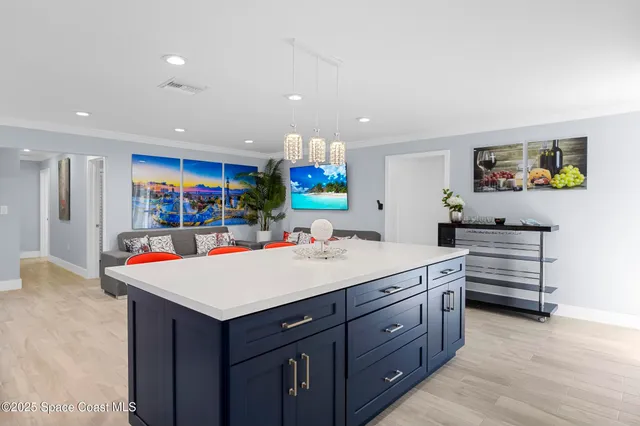 a view of kitchen with stainless steel appliances kitchen island a large island in the center
