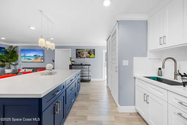 a kitchen with kitchen island a sink stove and cabinets