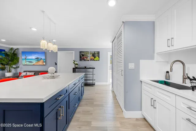 a kitchen with kitchen island a sink stove and cabinets
