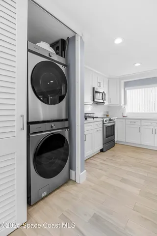 a view of a kitchen with a washer and dryer