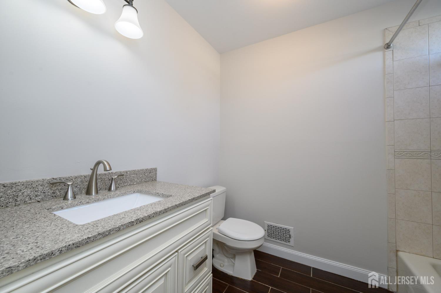 37 Helena Street East Brunswick, NJ 08816 - Photo 14 of 41 a bathroom with a granite countertop sink and a toilet