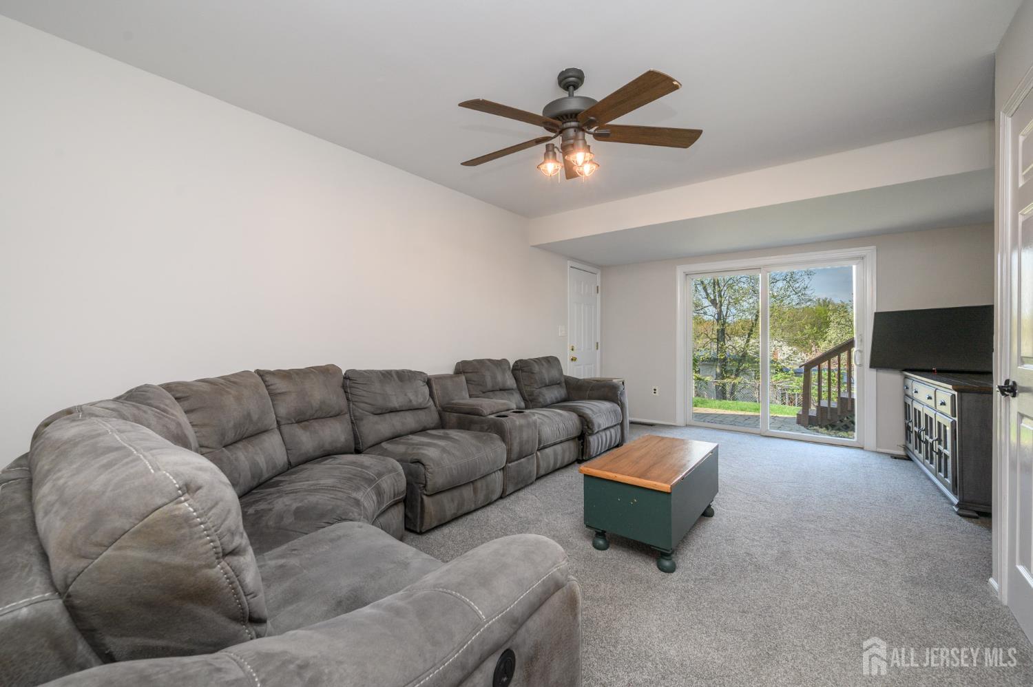 37 Helena Street East Brunswick, NJ 08816 - Photo 24 of 41 a living room with furniture a flat screen tv and a large window