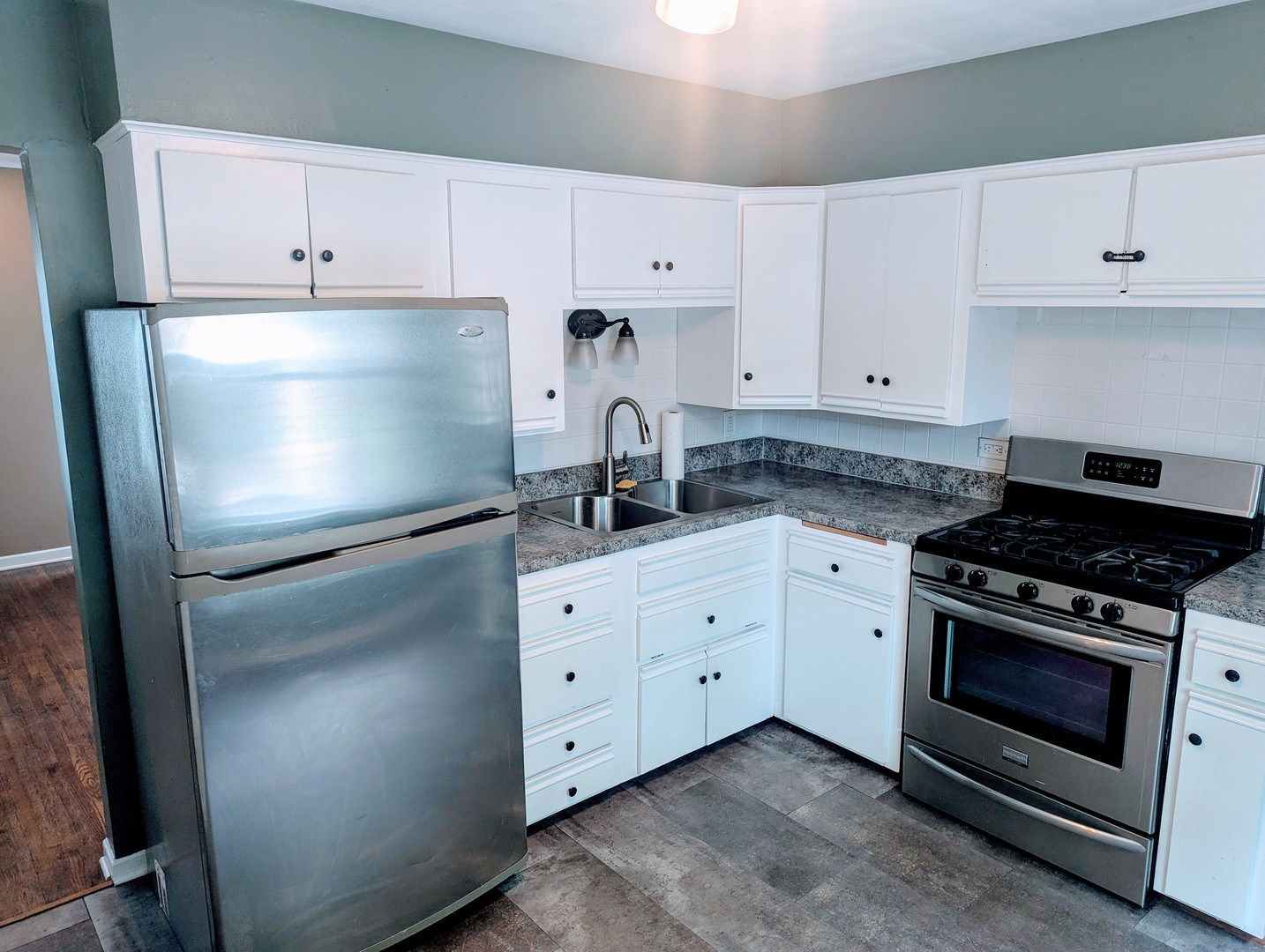 515 South Cedar Road New Lenox, IL 60451 - Photo 7 of 19 a kitchen with granite countertop white cabinets and stainless steel appliances