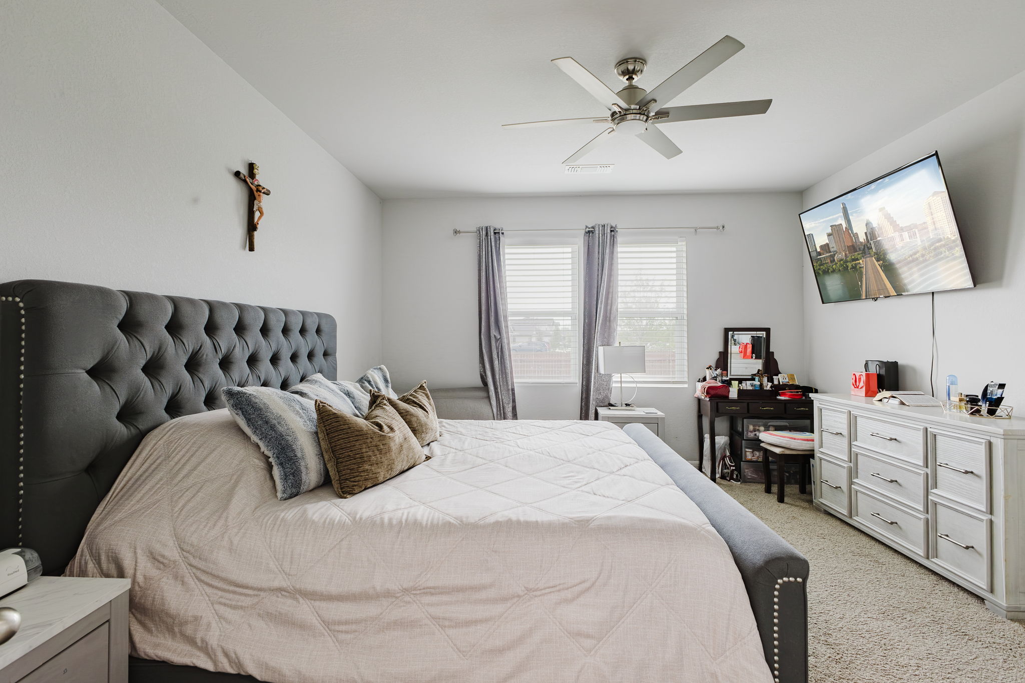 307 Watercourse Way Bastrop, TX 78602 - Photo 13 of 35 a bedroom with a bed and a chandelier