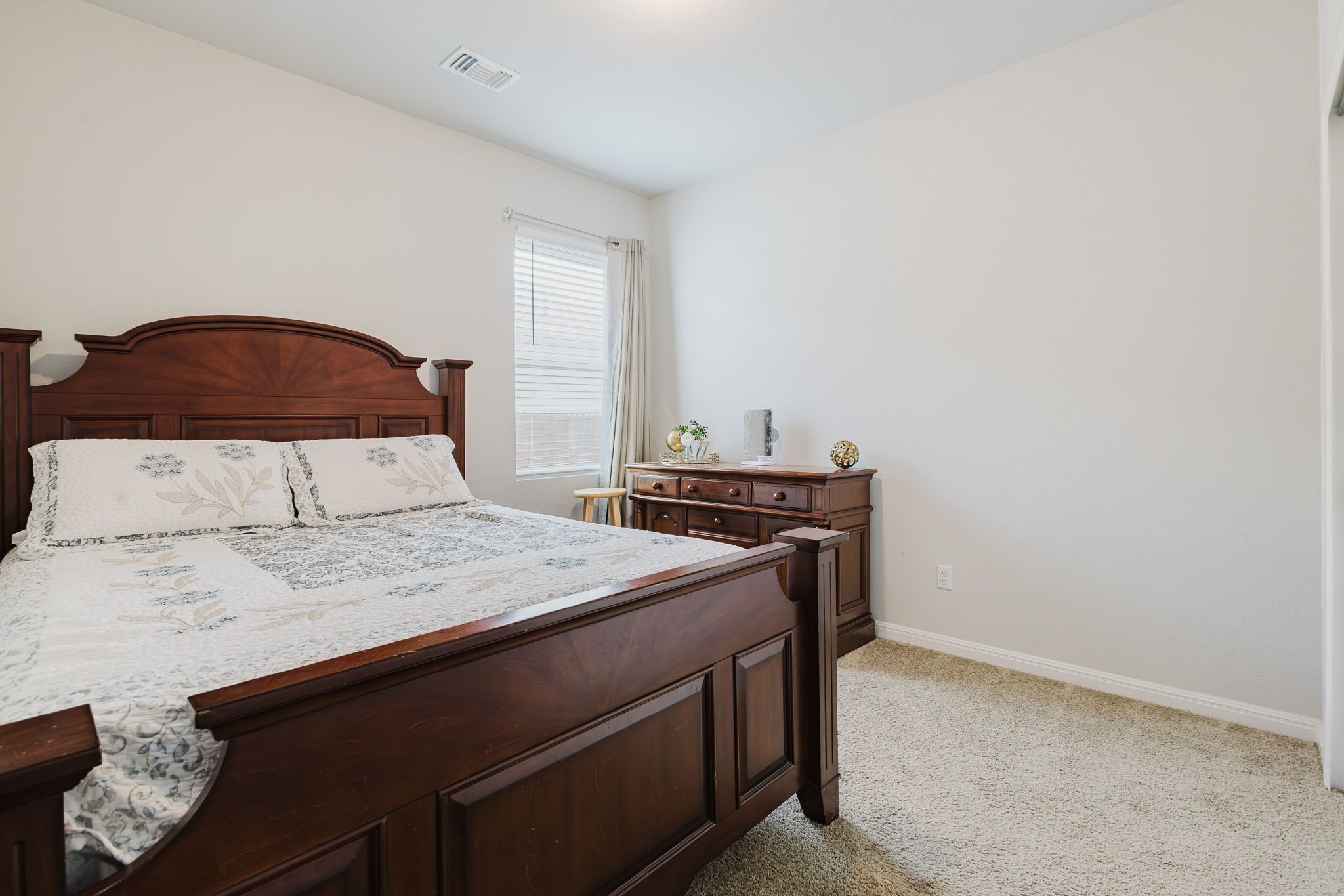 307 Watercourse Way Bastrop, TX 78602 - Photo 18 of 35 a bedroom with a bed and a dresser